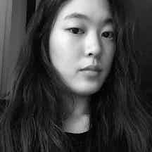 Black and white head and shoulders photographic portrait of Jiye Kim.