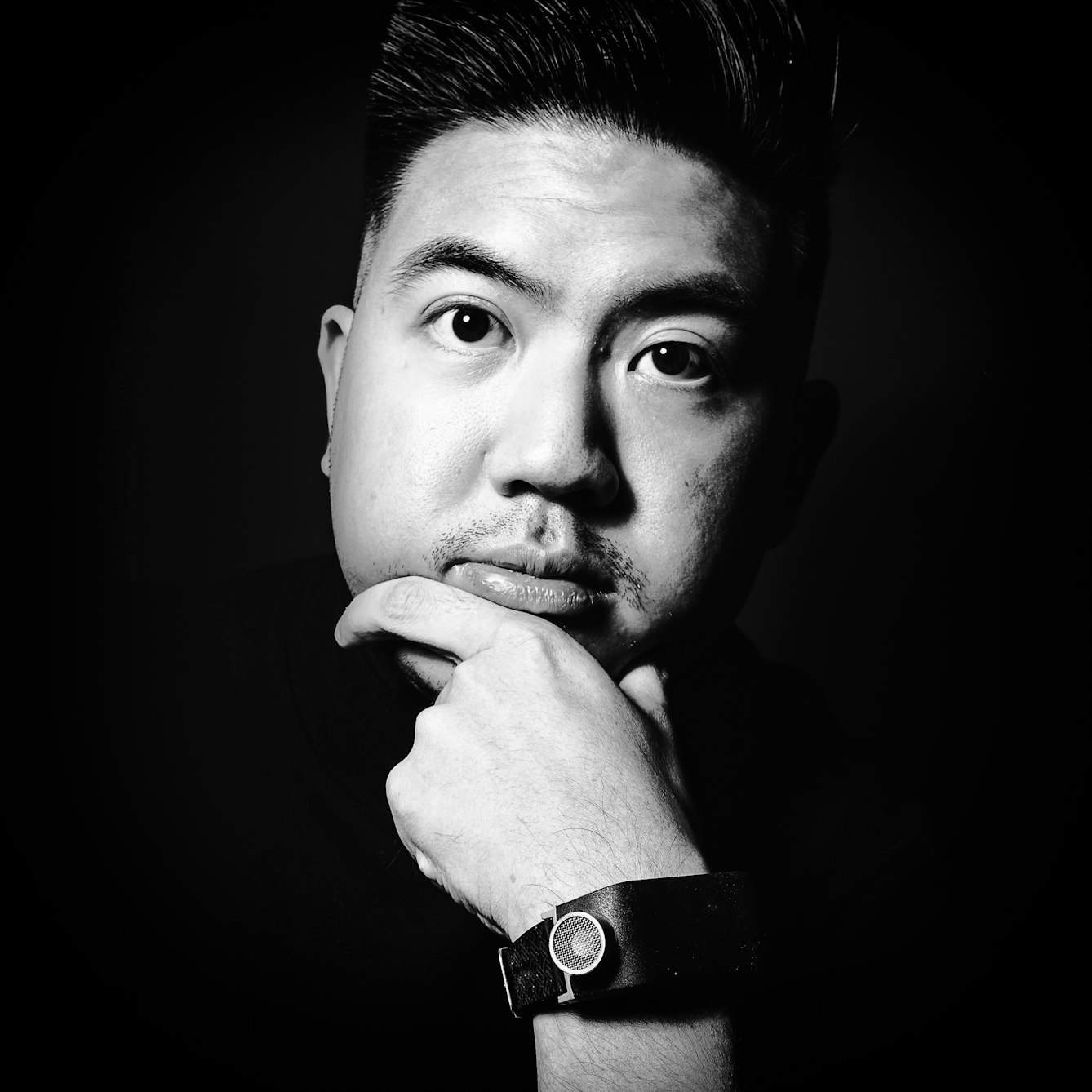 Black and white head and shoulders photographic portrait of Alex Lee.