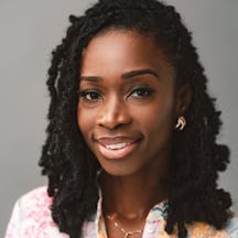 A headshot of Joelle, who is smiling into the camera