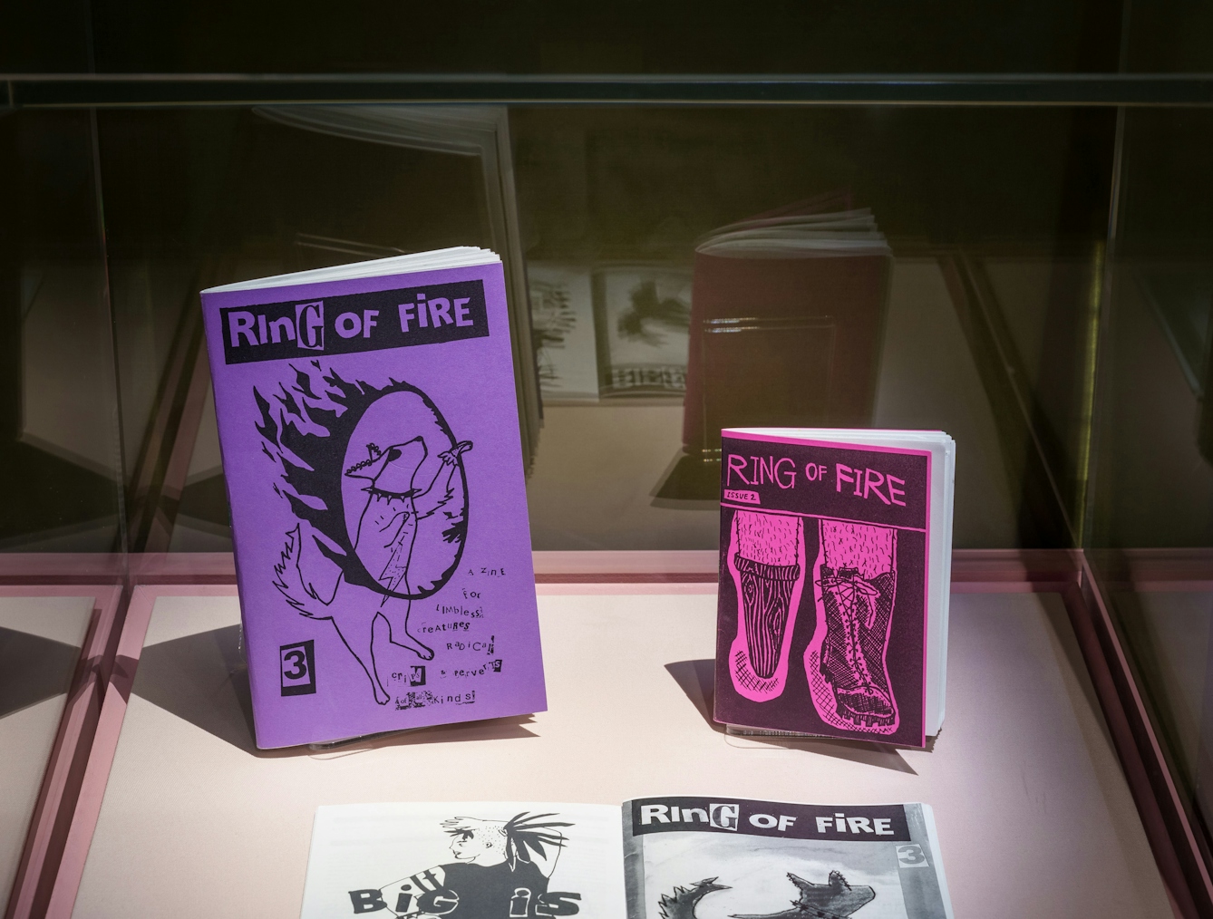 A display case containing 3 zines from the 'Ring of fire' series by E.T. Russion.
