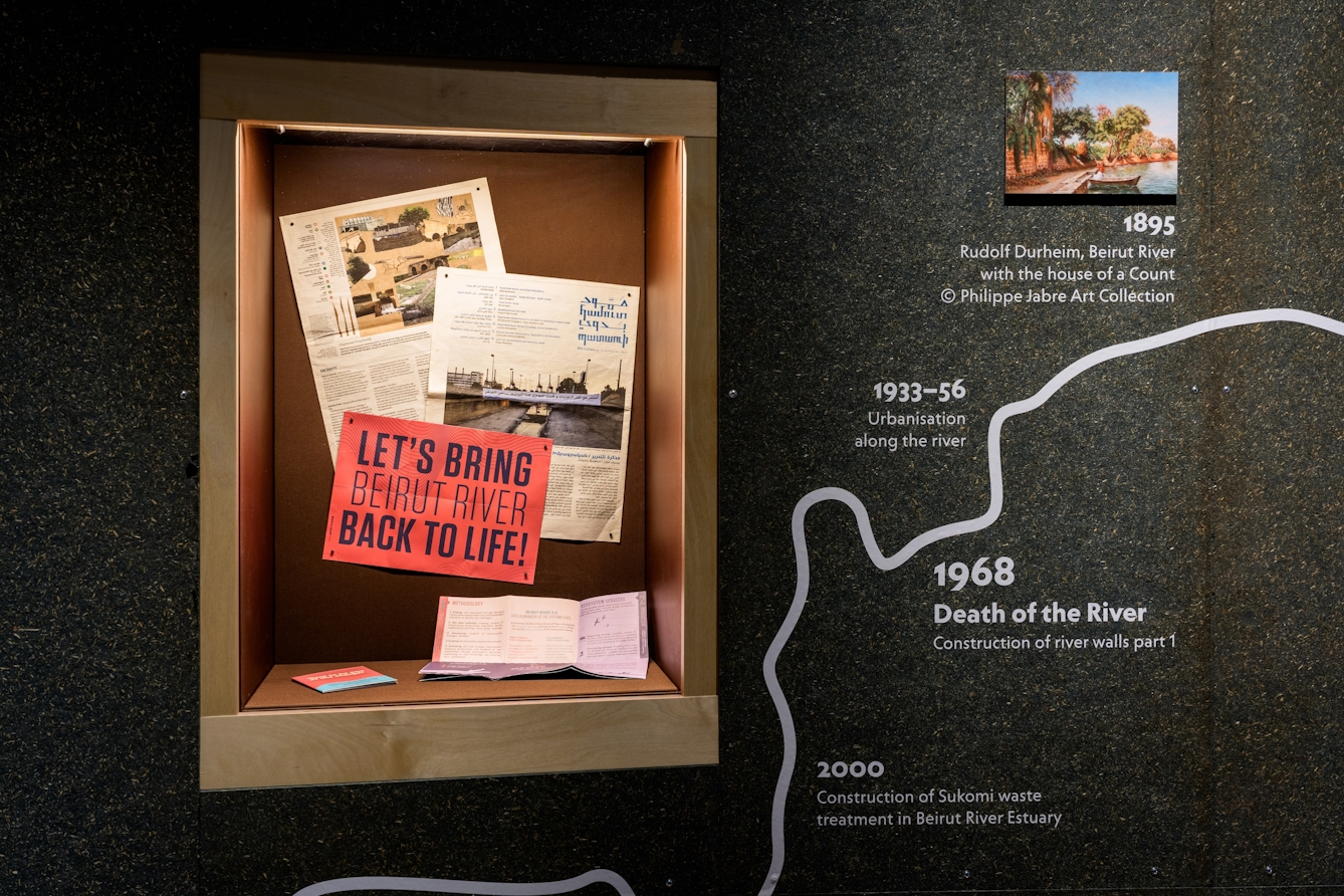 A display of newspaper articles and pamphlets about the Beirut River.