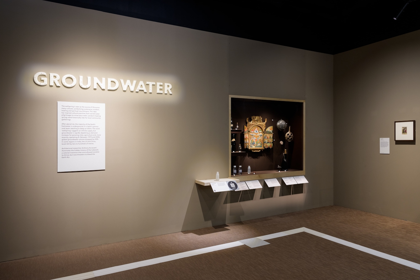 A large ceramic sign that reads 'Groundwater' with a display containing a painting of a healing spring in Istanbul in the background.