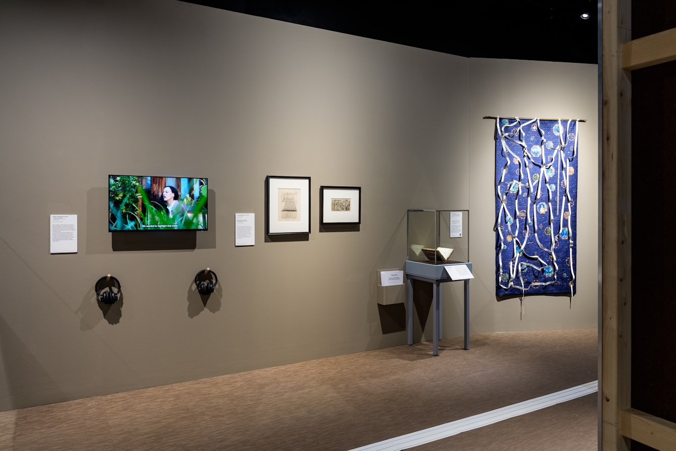 A wall featuring a contemporary textile artwork, historical engravings about the history of wells in London and a film about the Black Mary Project.
