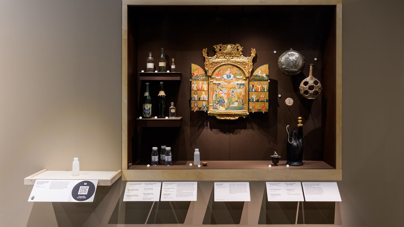 Wall-mounted painting of a healing spring in Istanbul; bottles of medicinal water and flasks.