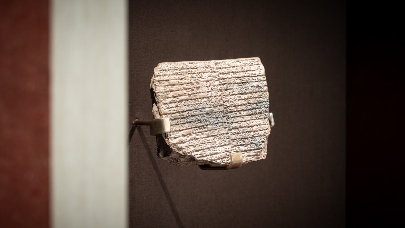 Segment of an old clay tablet with inscriptions.