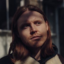 A black and white photograph of the head and shoulders of Lewis Khan.