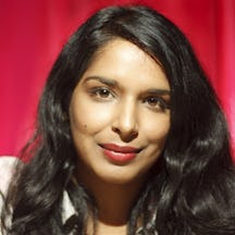 Head shot of a woman with long hair, smiling directly to camera.