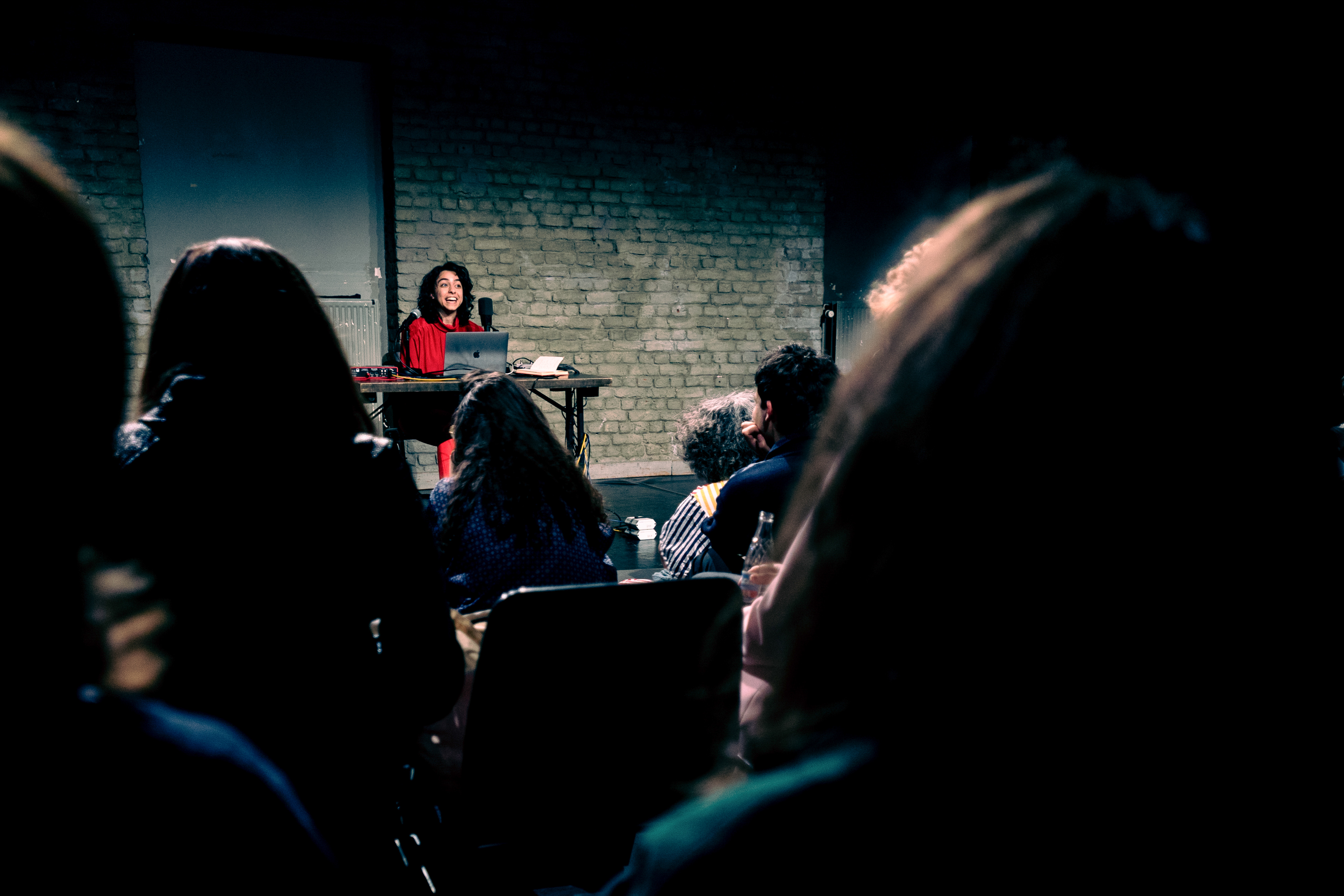 Bint Mbareh performing on a stage with instruments in front of an audience.