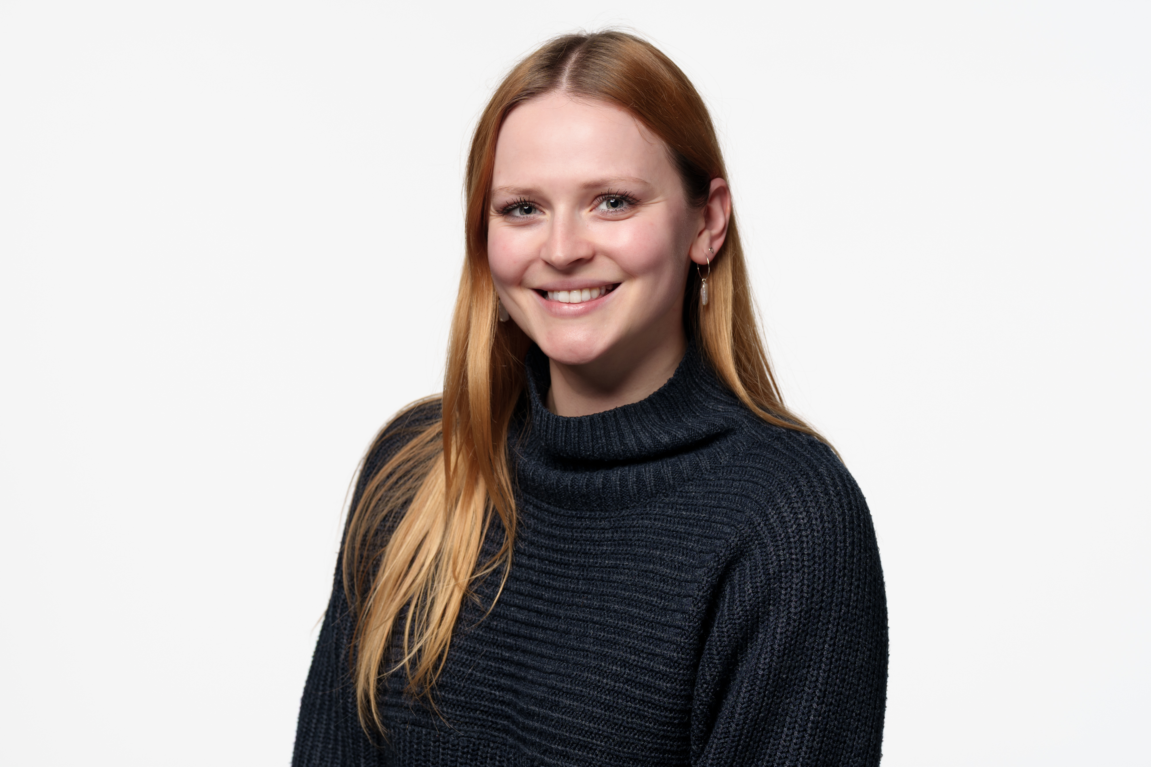 A headshot of Holly Houlton smiling into the camera.