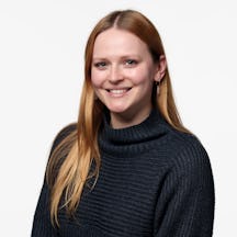 A headshot of Holly Houlton smiling into the camera.