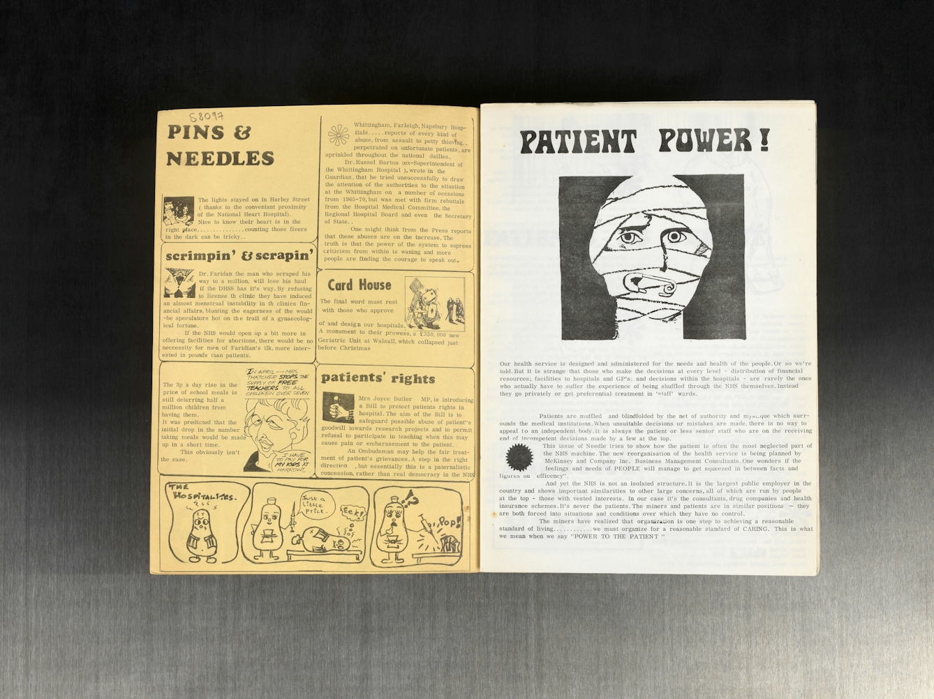 A two-page spread of a magazine laid out on a gray surface. The left page titled "Pins & Needles" features sections such as "scrimpin’ & scrapin’" with blocks of text and small illustrations including a comic strip with humanoid bottle characters at the bottom. There are smaller headlines like "patients’ rights" and "Card House" with accompanying text. The right page titled "Patient Power!" shows a large black-and-white graphic of a face wrapped in bandages with a safety pin through the mouth. Below is an article discussing patient treatment and rights within the NHS, advocating for empowering patients.