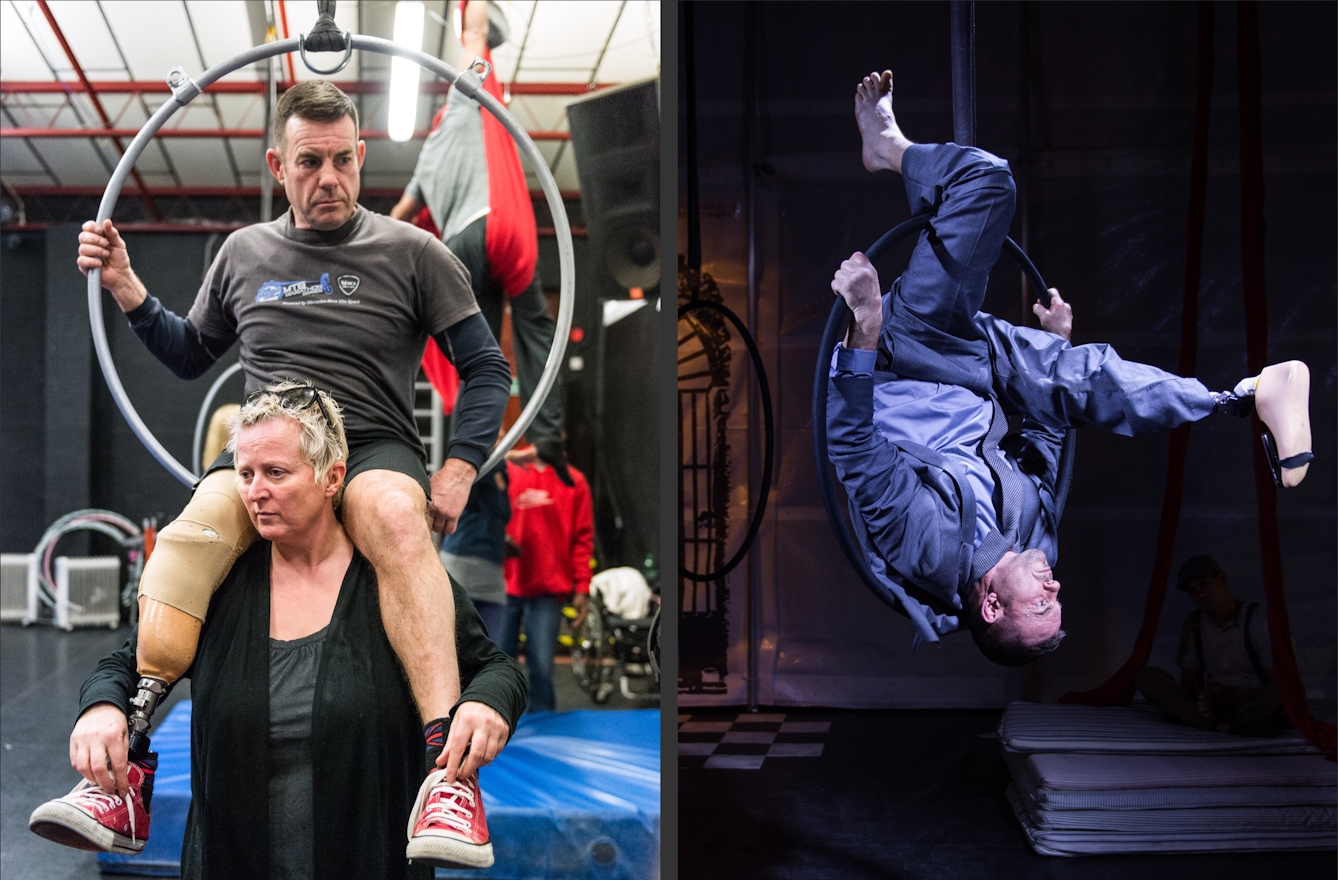 Photographic diptych. The image on the right shows a woman holding a man on her shoulders during a theatrical rehearsal. The man has a prosthetic right leg and is partially holding onto a large metal hoop suspended from the ceiling. The image on the right shows a male performer in a suit performing an up-side down stunt through a metal hoop suspended from the ceiling of a theatrical stage. Whilst suspended upside down, his prosthetic right leg is stretched out in front of him, as if completing a roll.