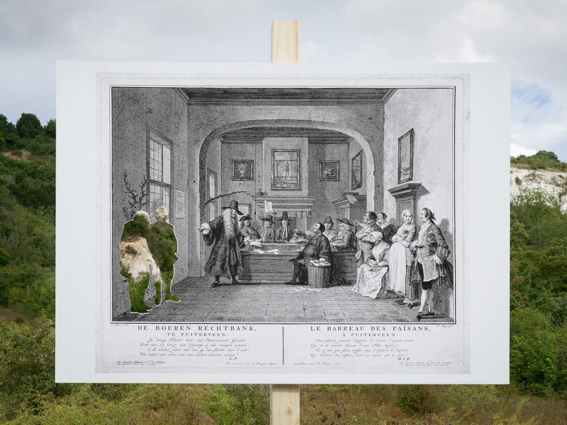 An etching of a courtroom photographed in front of a landscape featuring cliffs in the background. The two plaintiffs in the courtroom are cut out and the landscape is shown through the aperture.