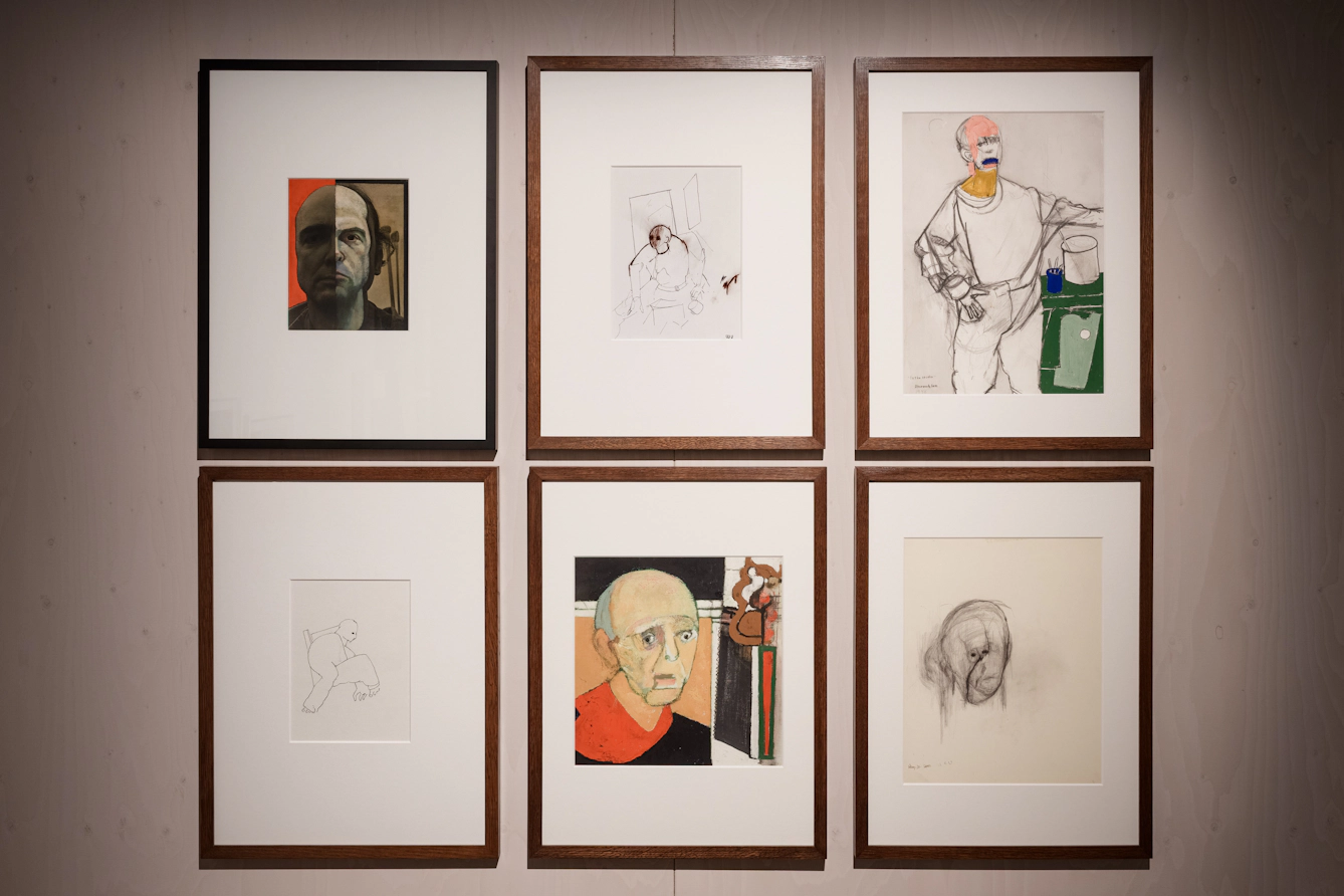 A wall of six framed self‑portraits by artist William Utermohlen.