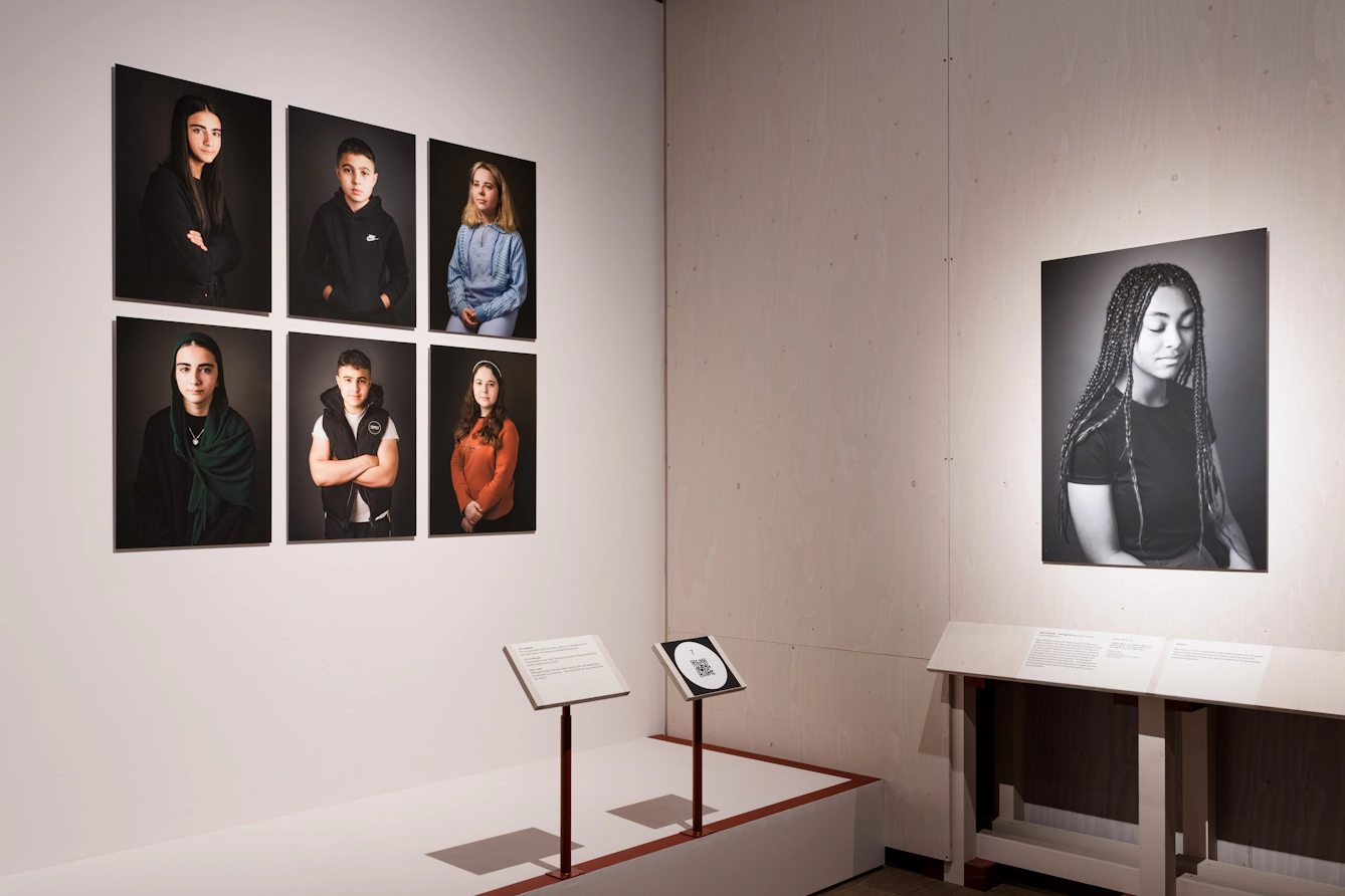Six portraits of young people are on the left, while a large black and white portrait of a teenager is on the right.