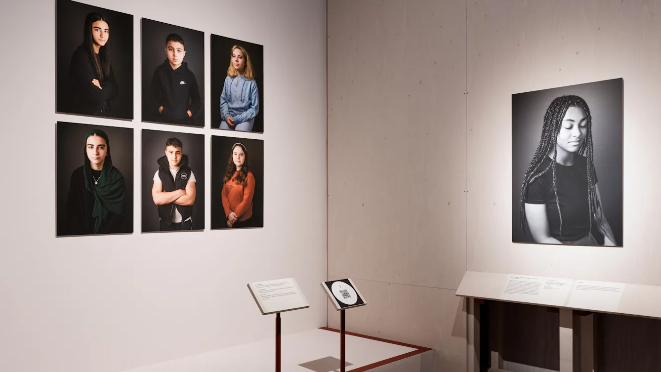 Six portraits of young people are on the left, while a large black and white portrait of a teenager is on the right.