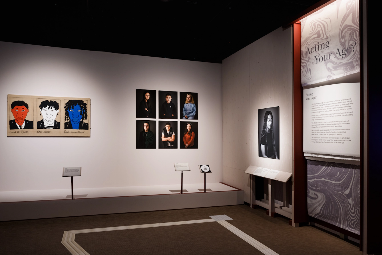 Artworks on a wall and a panel for Section 3 that says 'Acting your Age?'