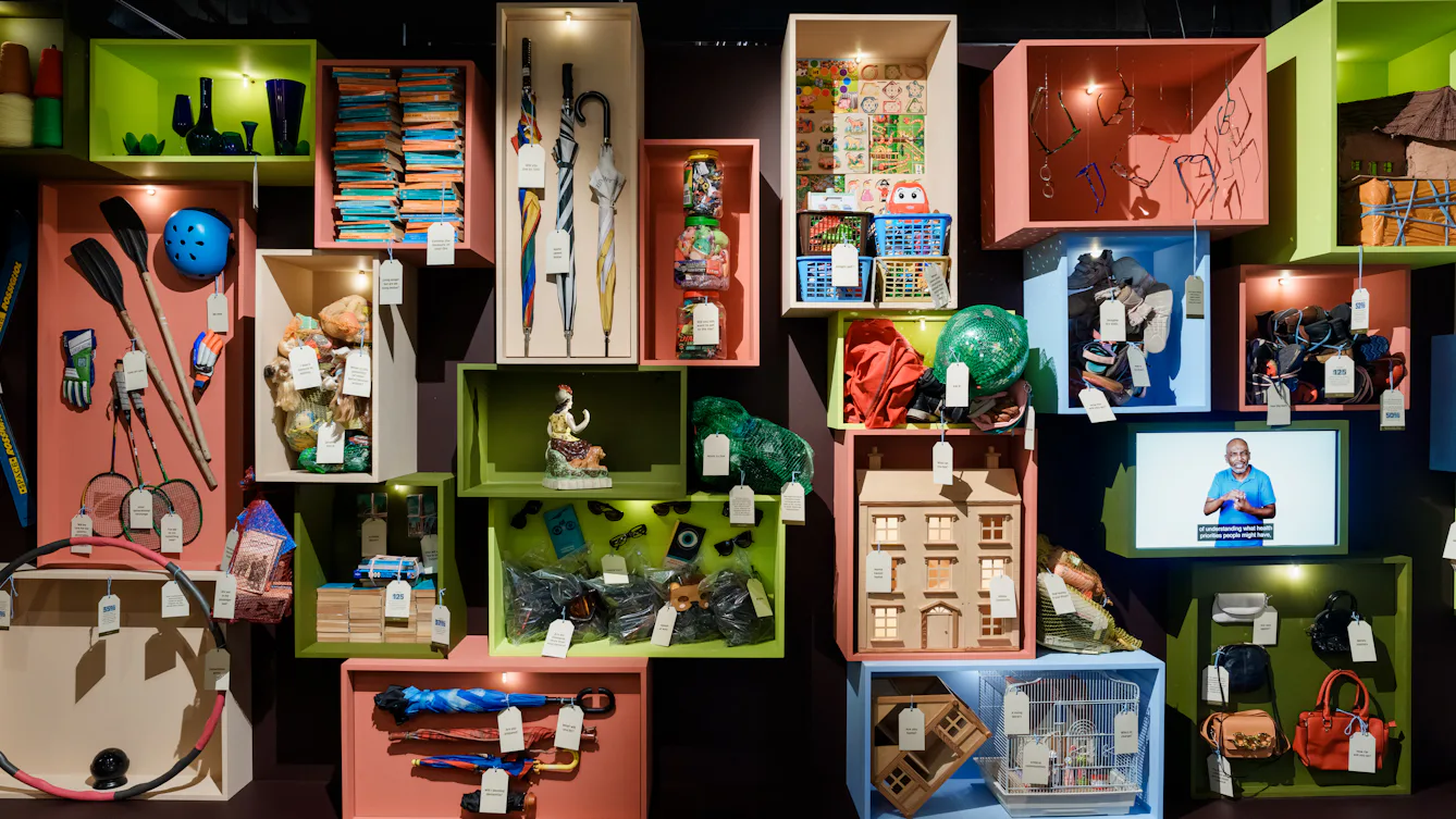 Colourful boxes are filled with miscellaneous objects, with labels hanging off them.