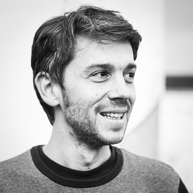 Black and white, head and shoulders portrait of Guillaume Chiron