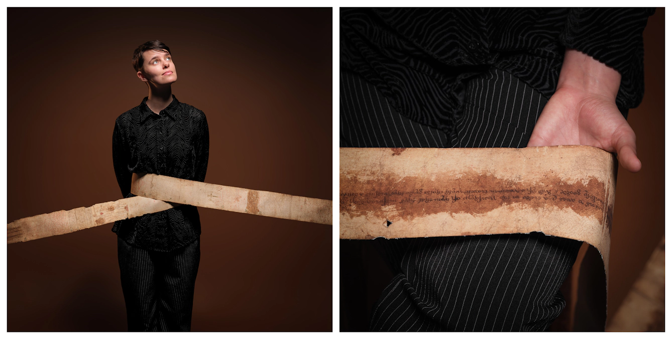 Photographic diptych, showing Kierri on the left, hands behind their back, with the facsimile birthing scroll looping around their midriff and out of the frame left and right. They gaze up and out of frame. On the right is a closeup of a section of the facsimile scroll, gently laid over Kierri's lap and open hand.