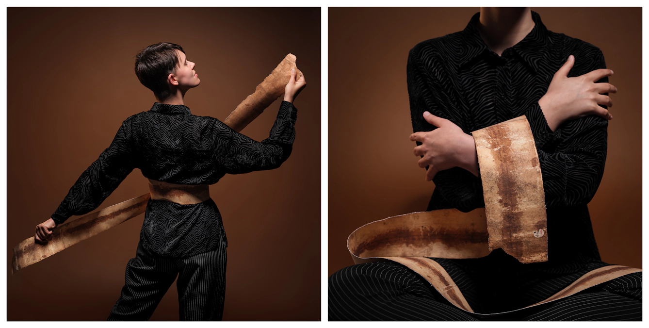 Photographic diptych, showing Kierri on the left, facing away from the camera holding either end of the facsimile birthing scroll tight, as it loops around their waist. On the right is a close up of Kierri seated cross legged on the floor, the facsimile scroll is concertinaed over their lap and looped over their folded arms.