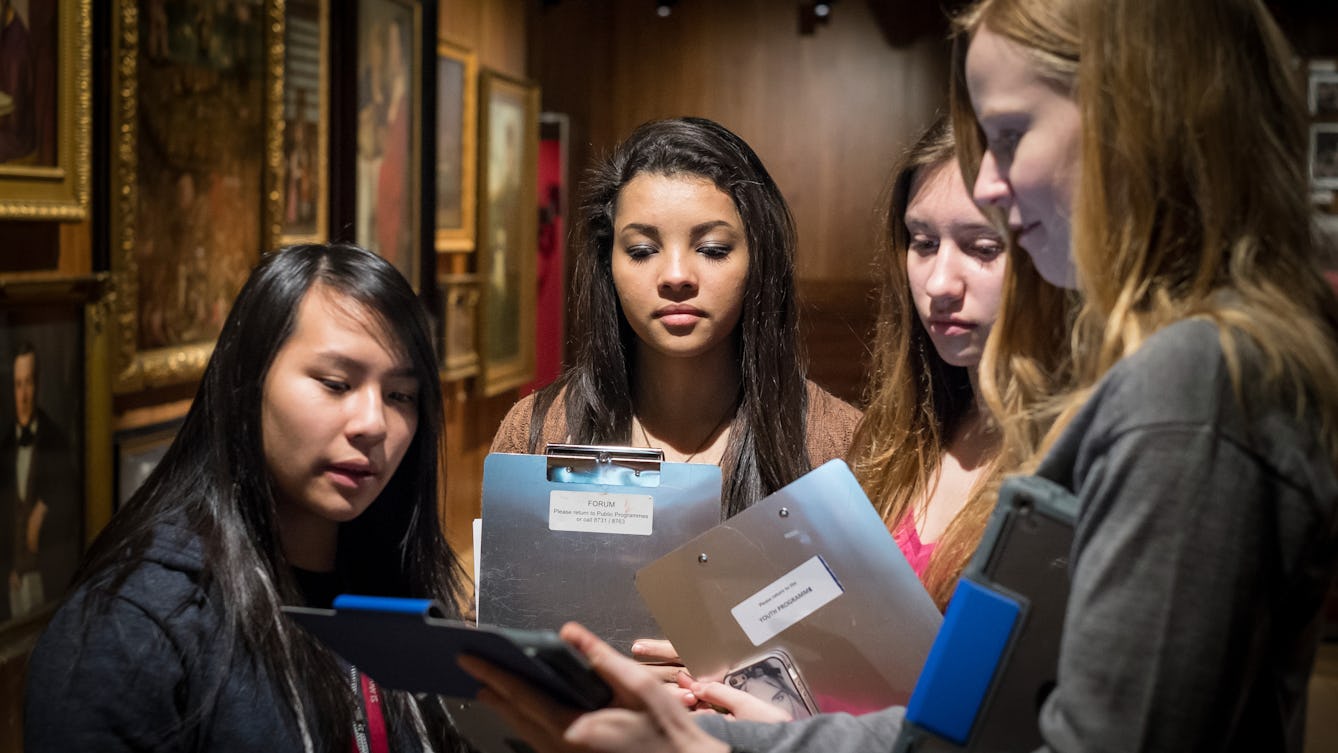Photograph of a group of young students in the Medicine Man gallery at Wellcome Collection.