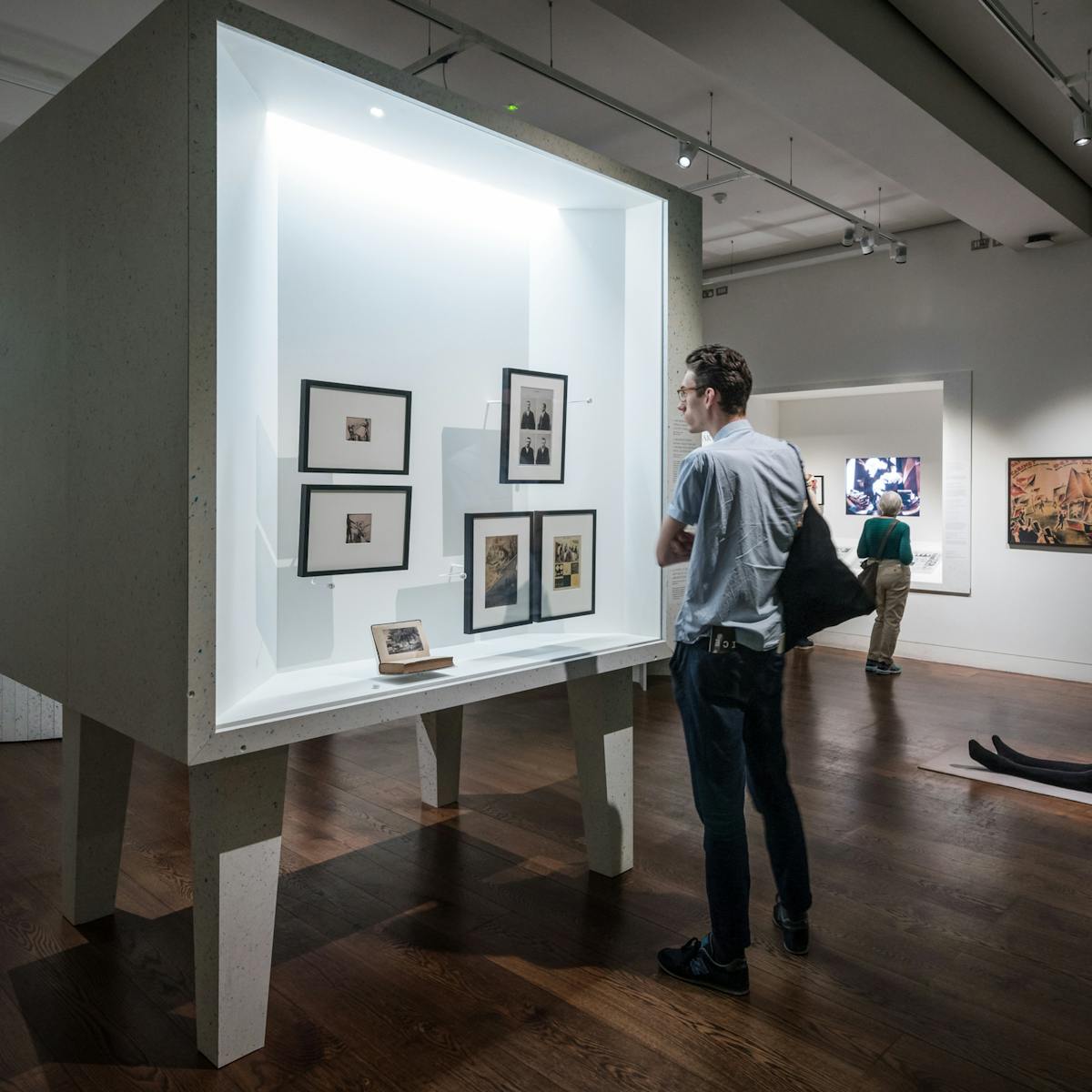 Photograph of visitors exploring the exhibition, States of Mind: Tracing the Edges of Consciousness at Wellcome Collection.