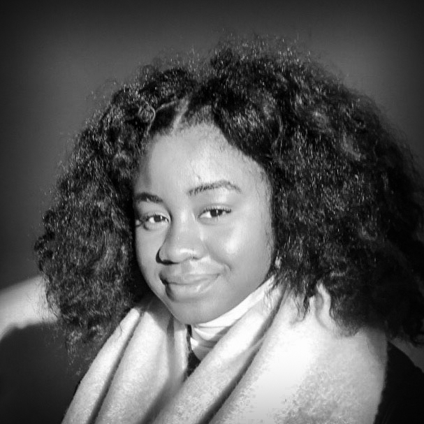 Black and white head and shoulders photograph of Maïa Walcott.