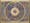 Image of colour manuscript in gold and blue, representing a horoscope. Large circle is in the middle with smaller circles in the centre. Inside these are symbols representing the signs of the zodiac.