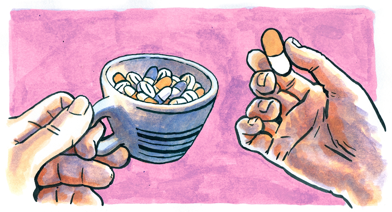 Hands holding a coffee cup filled with pills