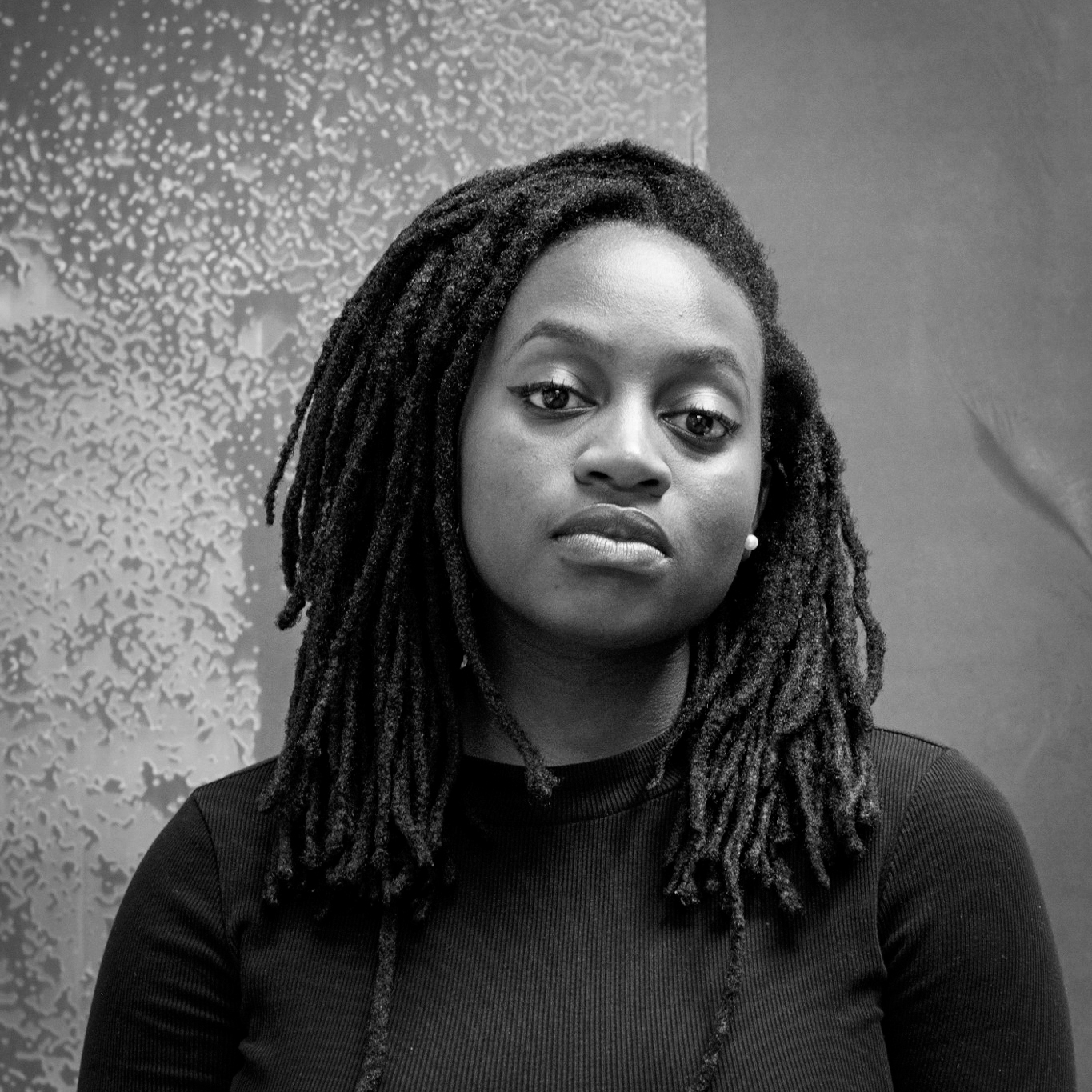 Black and white head and shoulders photographic portrait of Fungai Marima.