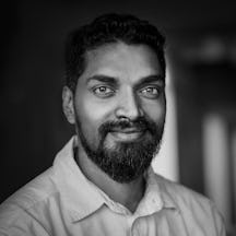Black and white head and shoulders photographic portrait of Ranganath Krishnamani.
