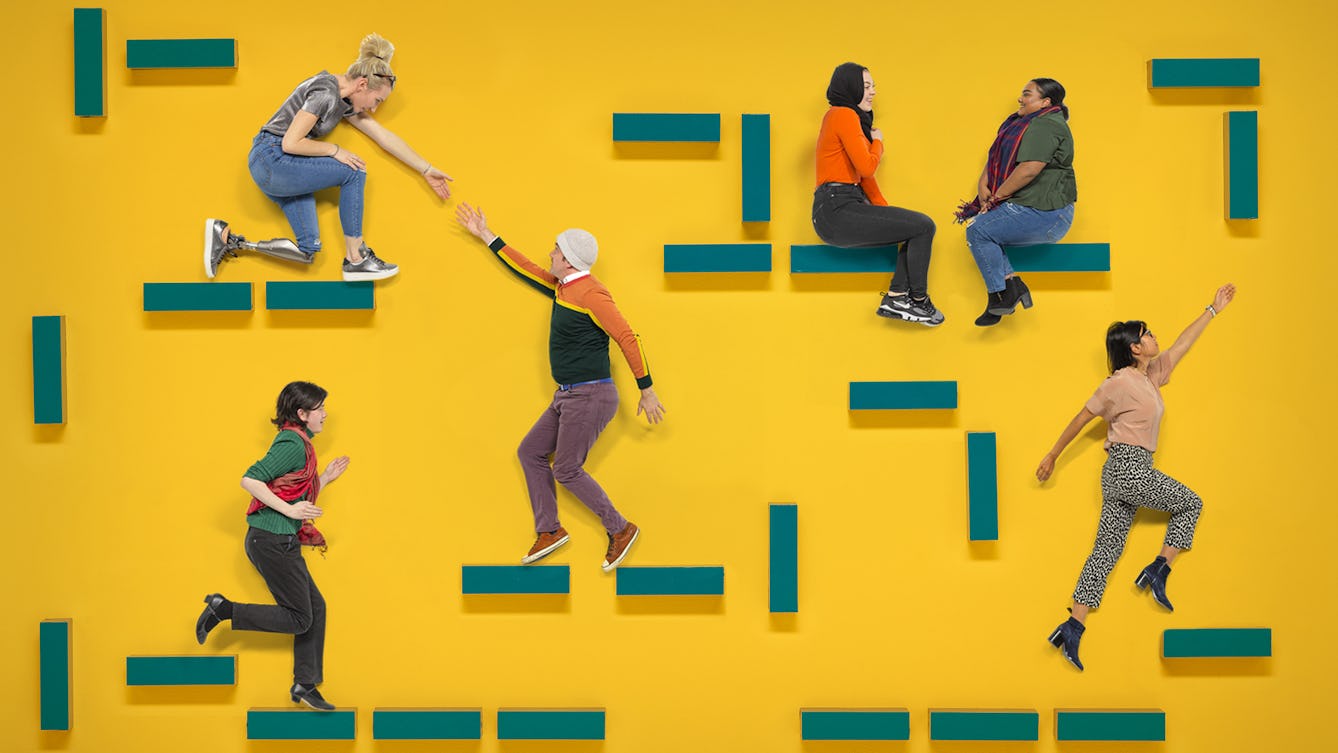 A group of people in various poses on a yellow background. They are sitting, standing, running and interacting with each other on blue blocks suspended in the air. 