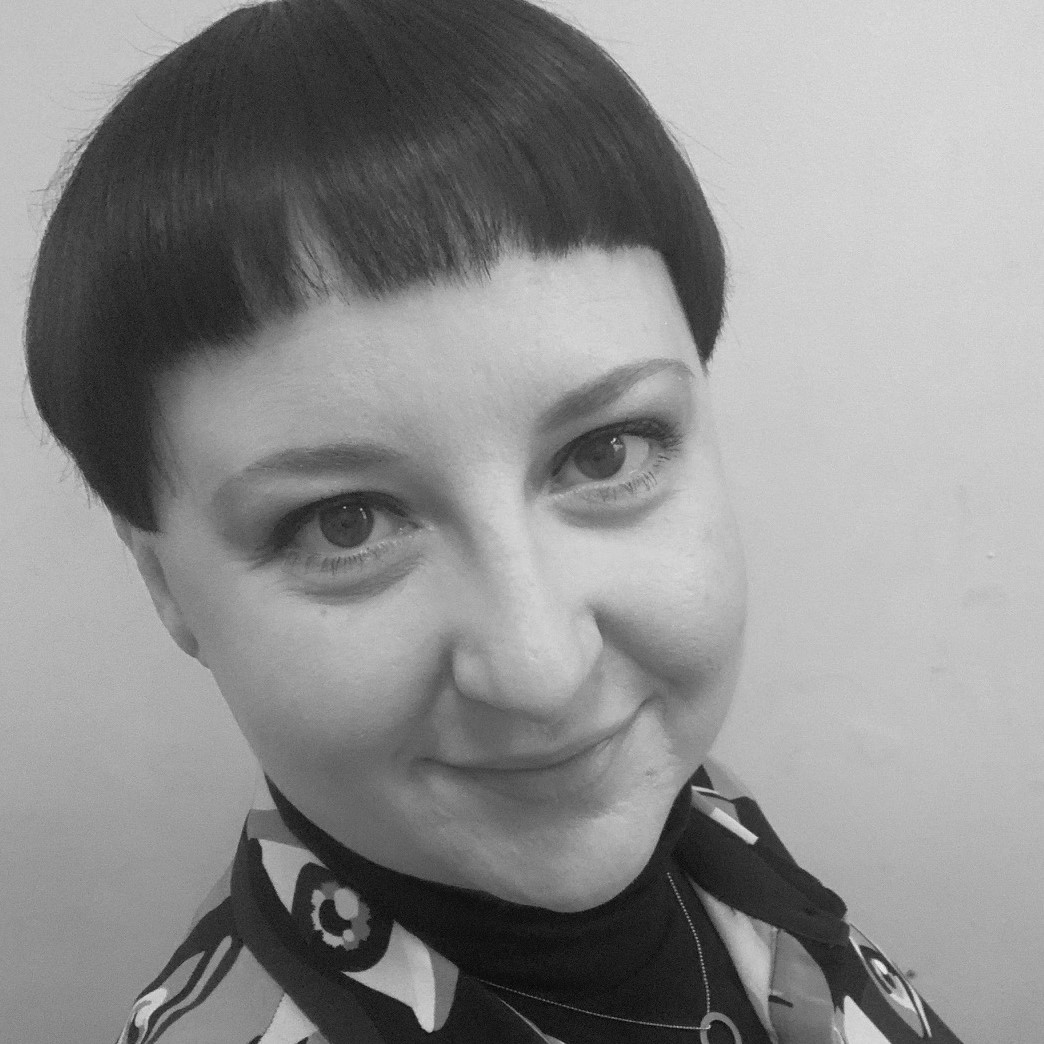 Black and white headshot of Wellcome Collections Development Manager Mel Grant, a smiling white woman with short dark hair.