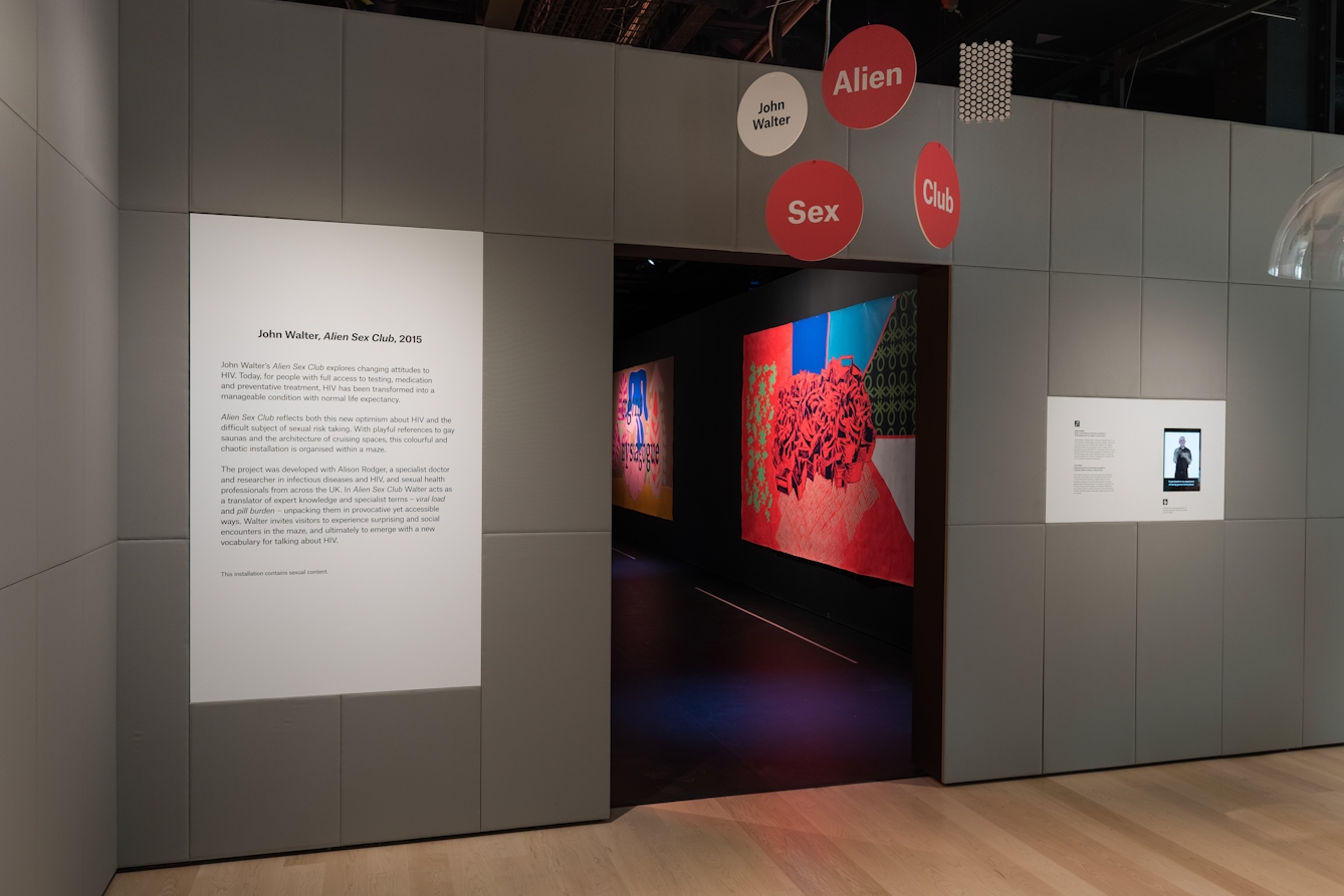 Photograph of the entrance to a gallery installation showing the introduction text panel.