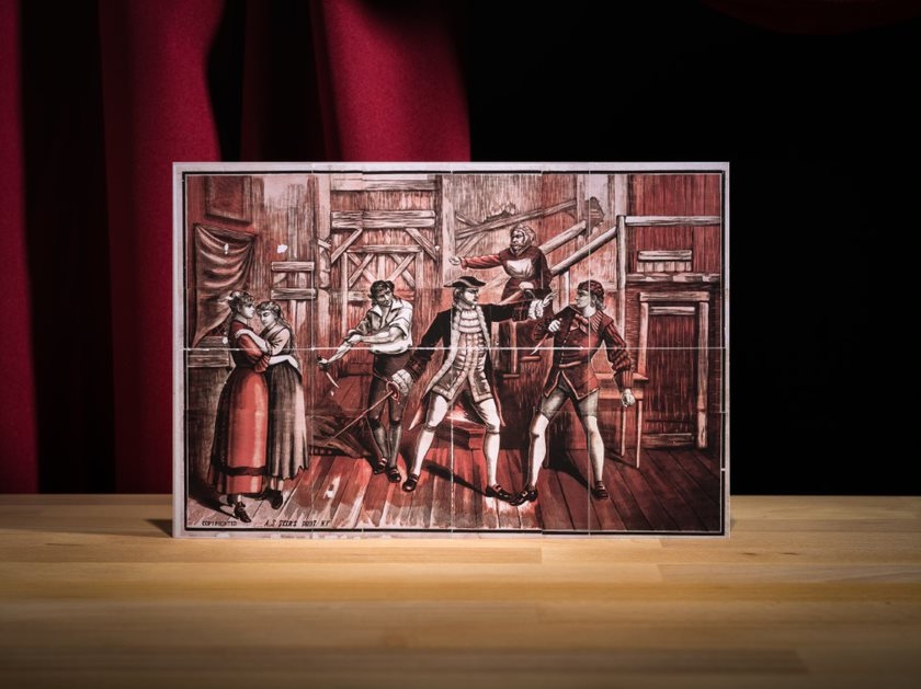 Coloured performing arts poster showing three men fighting with daggers & a sword while two women stand to side and woman gestures from stair.