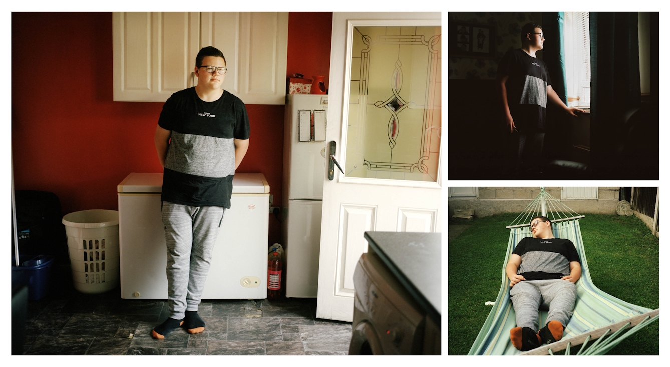 A cluster of 3 photographs, one large and two. The small top right photograph shows a teenage boy standing in a dark room looking out of the window. The small photograph bottom right shows the same boy lying in a hammock with his eyes closed. The large photograph on the right shows the same boy standing in a utility room leaning on a chest freezer.