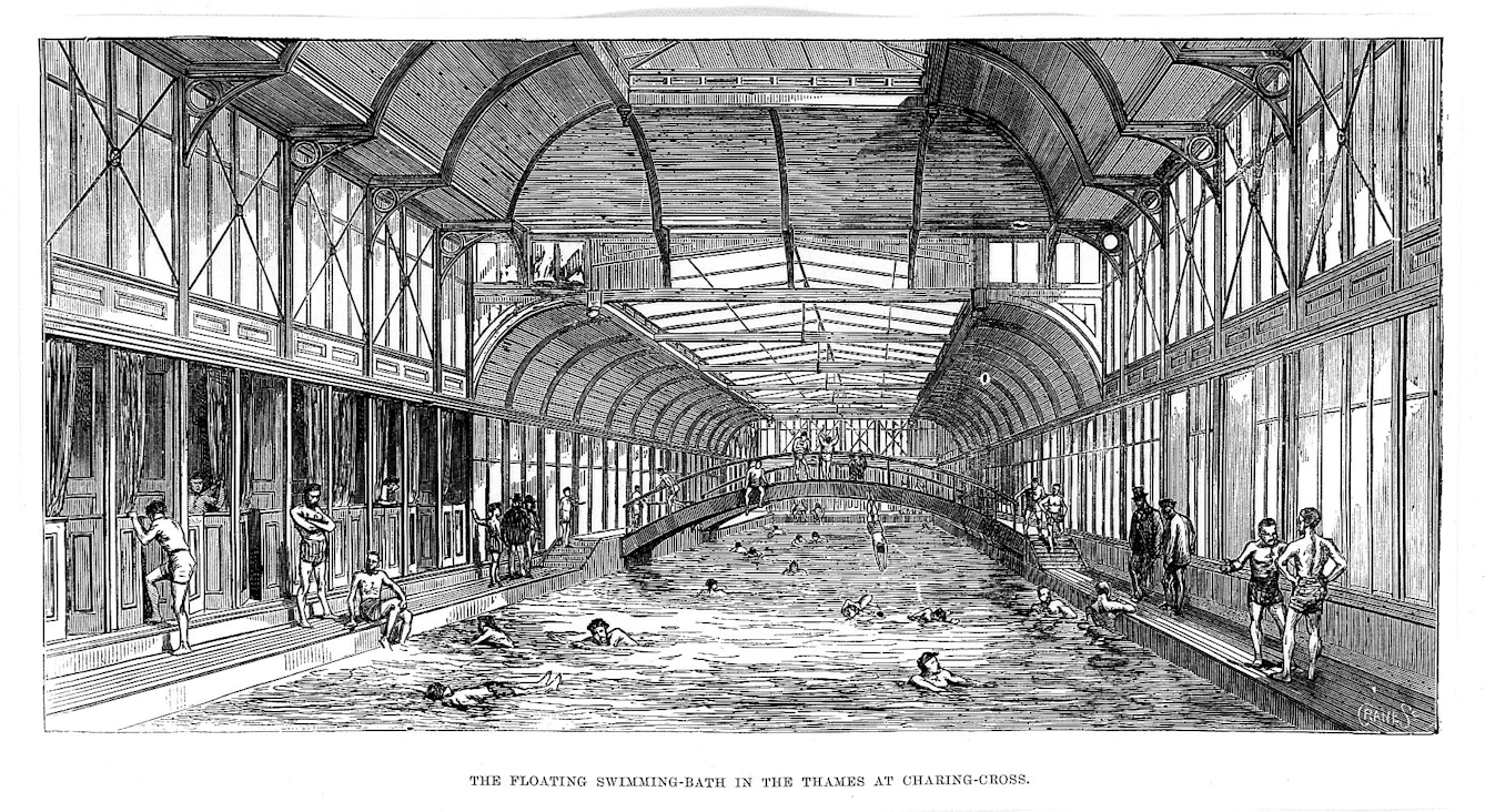 Black and white engraving of the inside of a swimming bath featuring a bridge and people diving, swimming, and standing or paddling at the edge. Some of the spectators are wearing top hats.