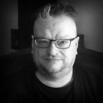 Black and white, head and shoulders portrait of Rick Burgess.