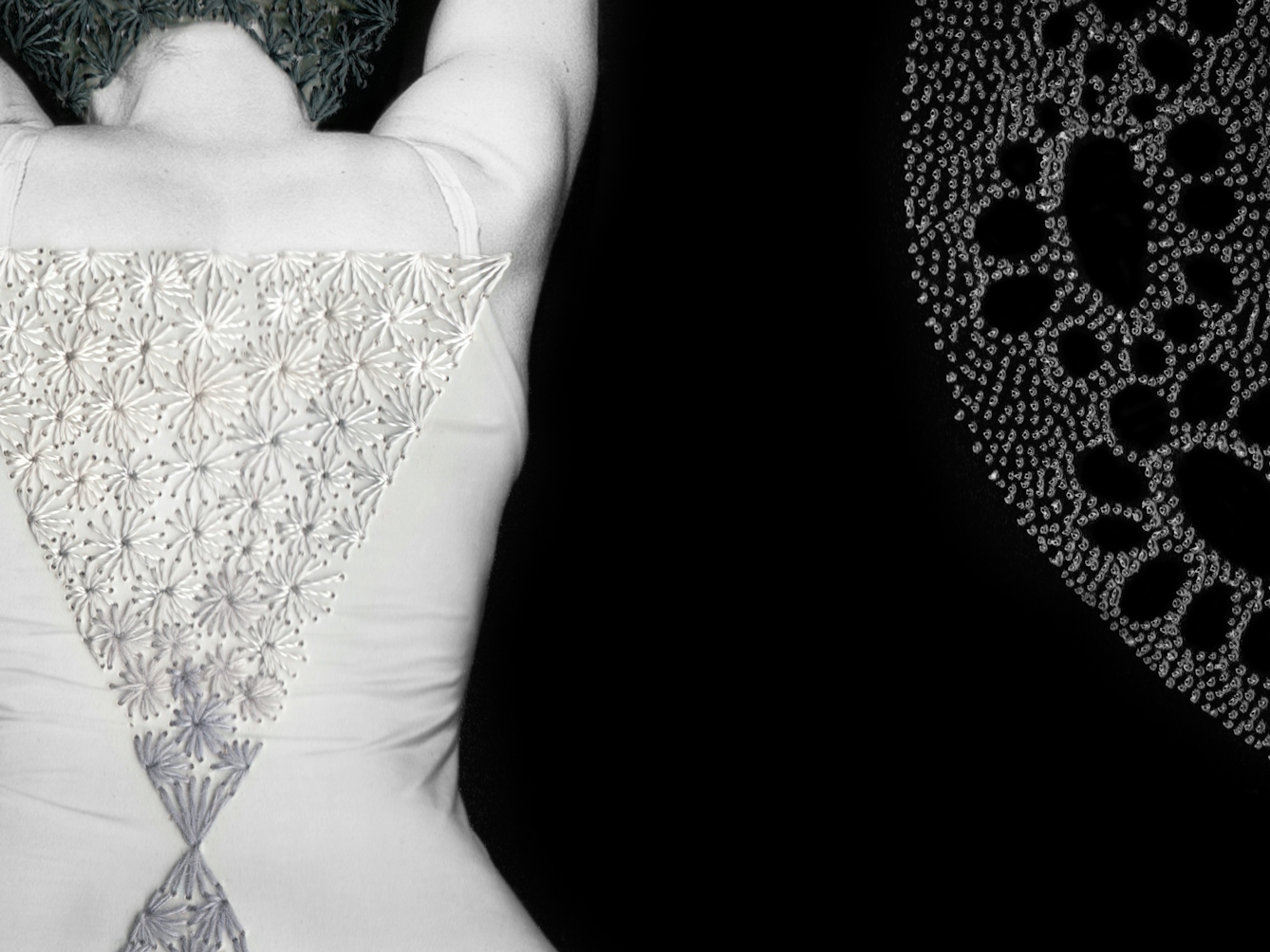 Artwork made up of a black and white photograph of a female figure from behind, from the waist up, against a black background.  Embroidered into the photographic print with grey thread is a crisscross floral pattern which exactly covers her head and hair. Across her back, embroidered in silver thread is a large triangle connected to a smaller triangle. To the right of the figure is a large curved form made up of a layered texture of dots.