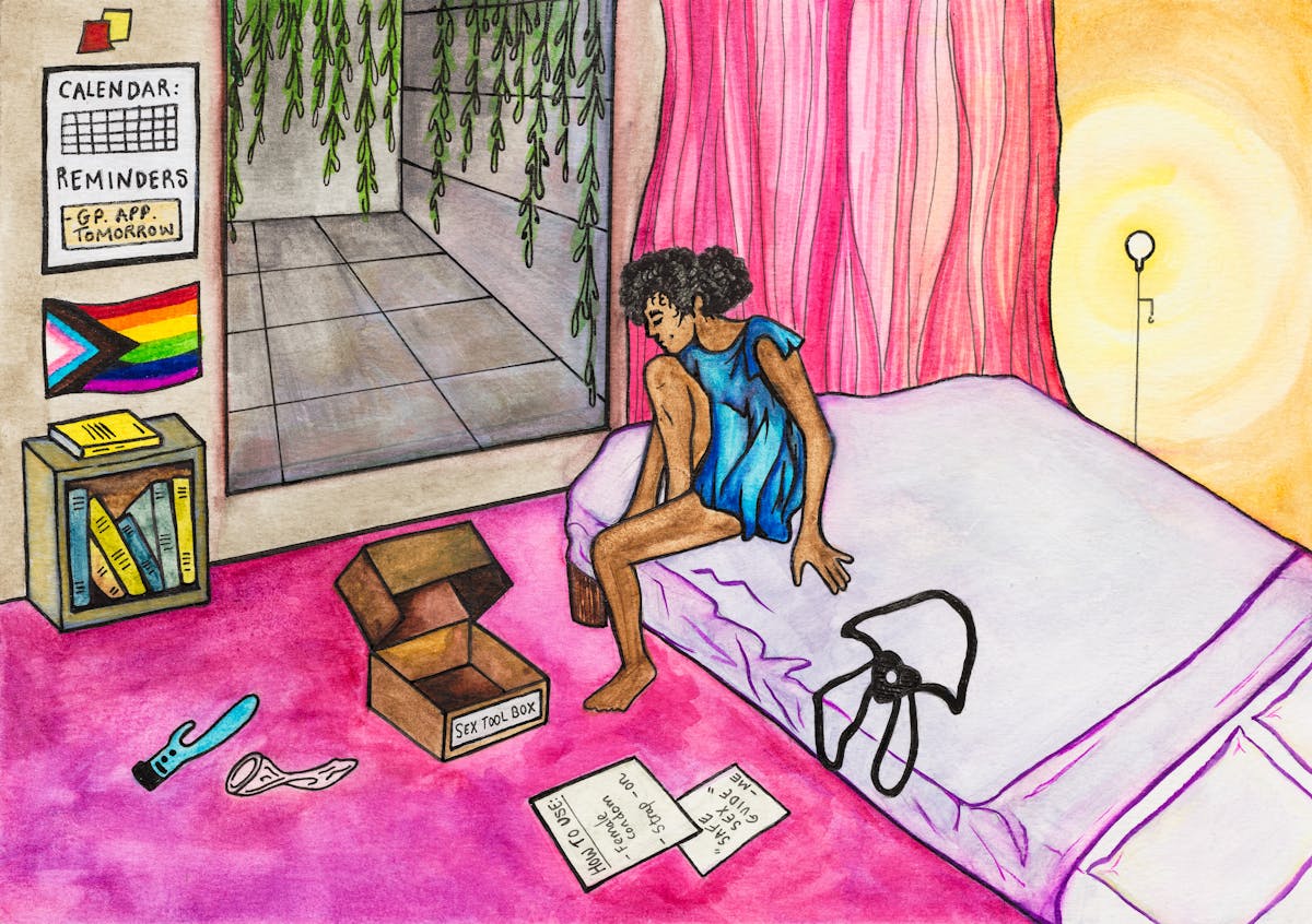 Colourful artwork made with paint and ink on textured watercolour paper. The artwork shows a scene in a bedroom with predominantly hues of pink, mauve and yellows. To the right is a double mattress on the pink carpet. Sat on the bed is a young woman in a blue dress. In front of her on the floor is an open brown box, with the words 'Sex tool box' written on the side. Scattered around the box is a blue dildo a female condom and set of instructions titled, 'How to use: female condom, strap-on. Safe sex guide - me'. On the wall is a Progress Flag and a calendar reminder for a GP appointment tomorrow.