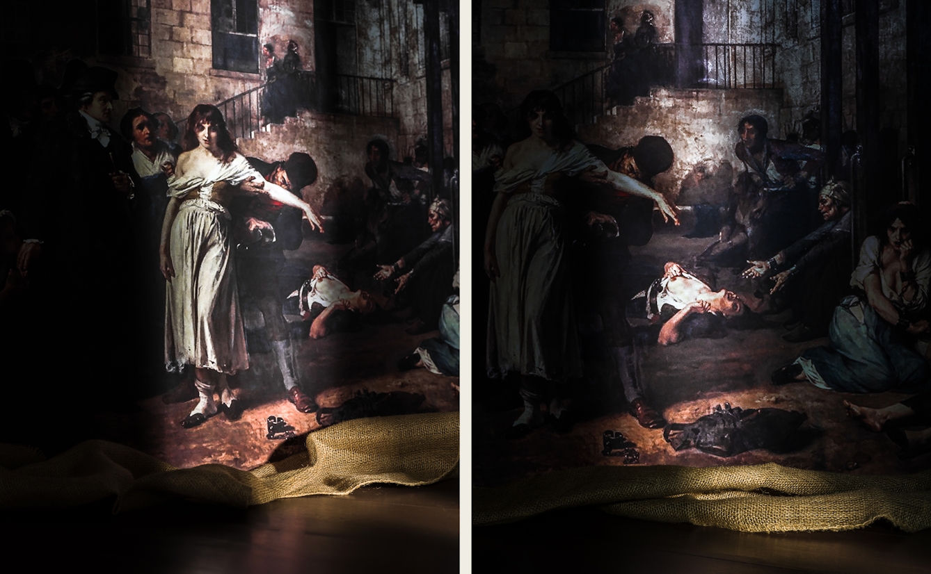 Photographic diptych showing two oils paintings. The image on the left shows a section of an oil painting resting on a hessian sheet. A shaft of light reveals a section of the painting showing a woman standing with her arm outstretched whilst a man removes a restraint from around her waist. The image on the right shows a section of an oil painting resting on a hessian sheet. A shaft of light reveals a section of the painting showing a woman lying on the floor open-mouthed, pulling her clothes to reveal her breast.