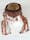 A photograph of a headdress made from brown material, decorated with clear, pink-red and green beads, and decorative metalwork.