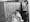 Three people chained to a telephone exchange, and a man with a beard.