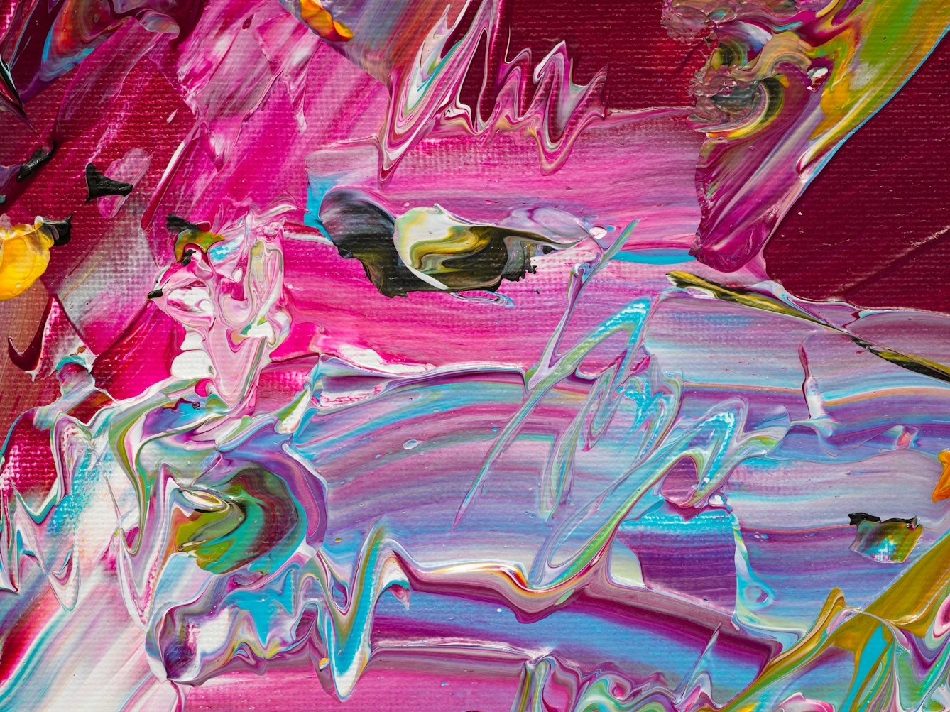 Photograph of close-up detail of a larger abstract  expressionist painting  utilising acrylic paint on a rectangular canvas in landscape orientation. A vast majority of the canvas surface contains many scattered, complex and confusing marks and gestures of vibrant and colourful tones - including yellow, pink, orange, turquoise, white. It's akin to a frenetic and overwhelming scene of repeated surprises and shocks.