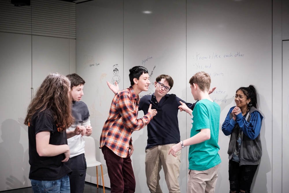 Photograph of a group of young people taking part in an improv comedy workshop as part of the Wellcome Collection Raw Minds programme.