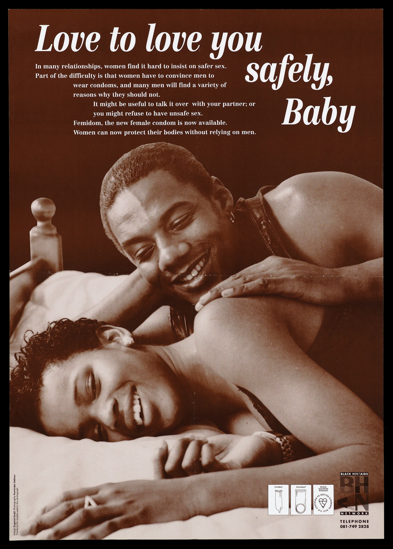 A black couple lie on a bed together smiling; advertisement for the new female condom by the Black HIV/AIDS Network. Brown lithograph, published in the 1990s.