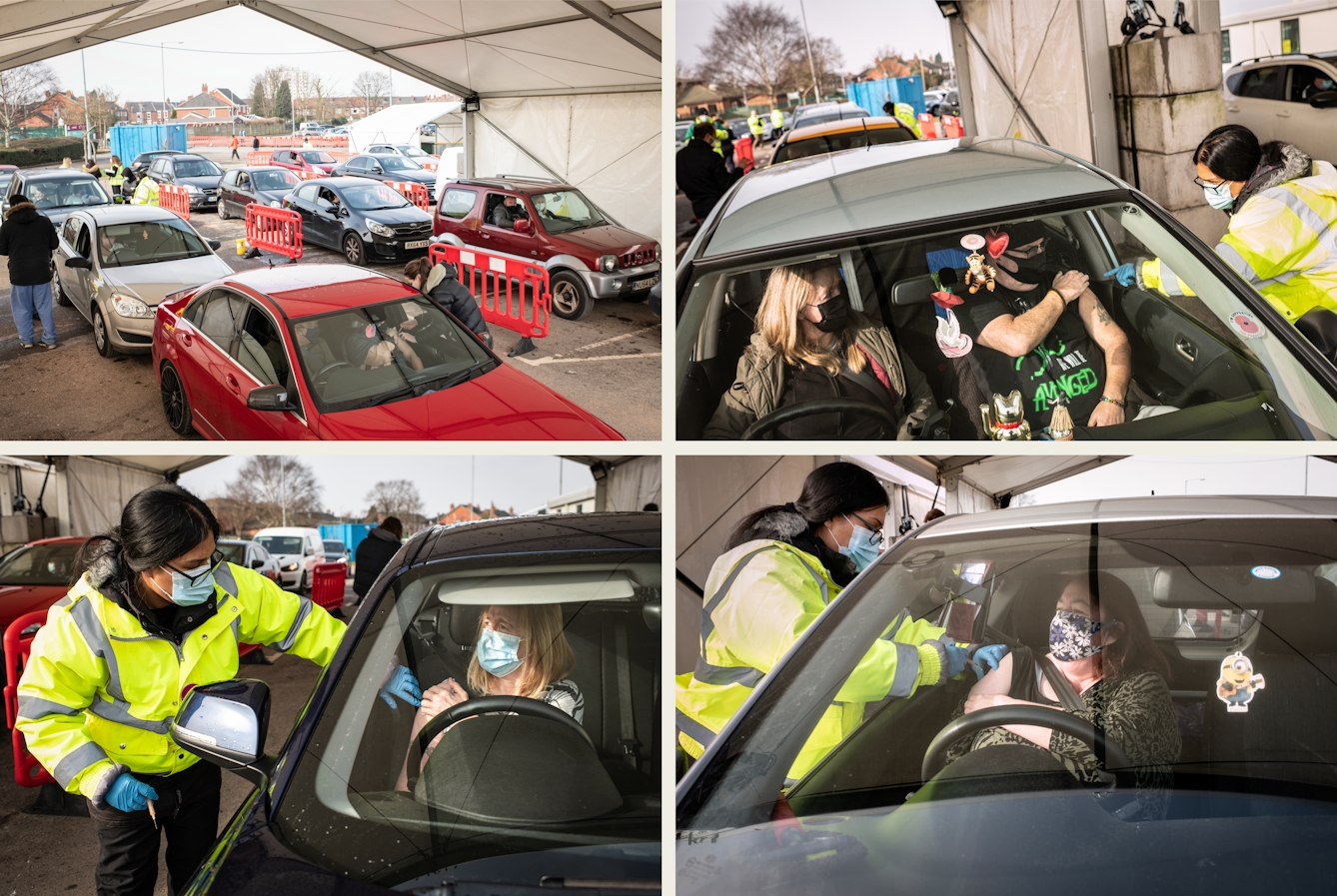 Grid of four photographs, two by two. Each image shows the scene of a drive-through vaccination centre. There are queuing cars waiting for the occupants' turn to received the vaccine. There are views through peoples' windscreens as they pull up their sleeve to receive the jab. A woman in a hi-viz jacket, blue latex gloves and a face covering works through the car side windows to administer the vaccine to the people inside the car.