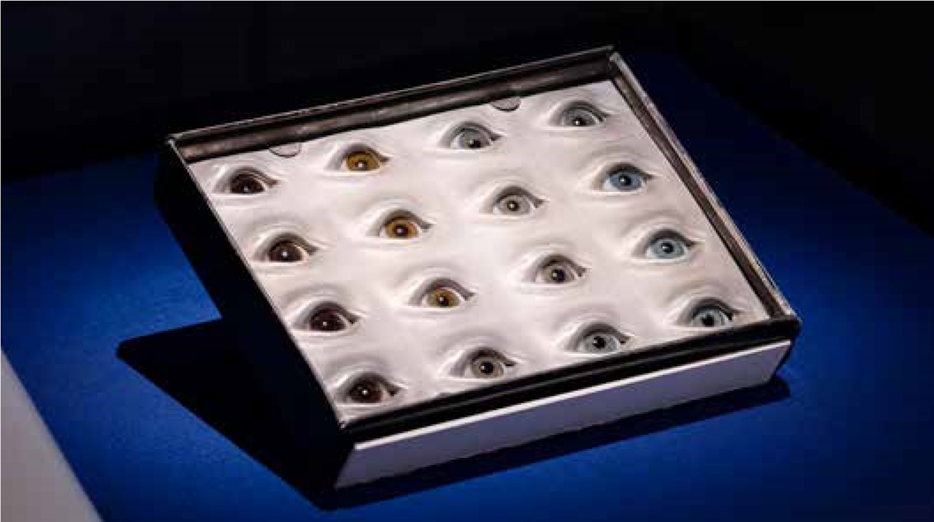 Box of 16 glass eyes of different shades used as an eye colour guage.