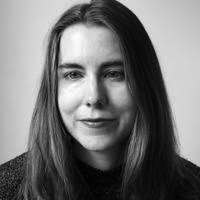 Head and shoulders photograph of a woman with shoulder-length straight dark hair.